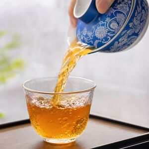 artisan Longquan celadon tea set pouring - glaze teapot in use