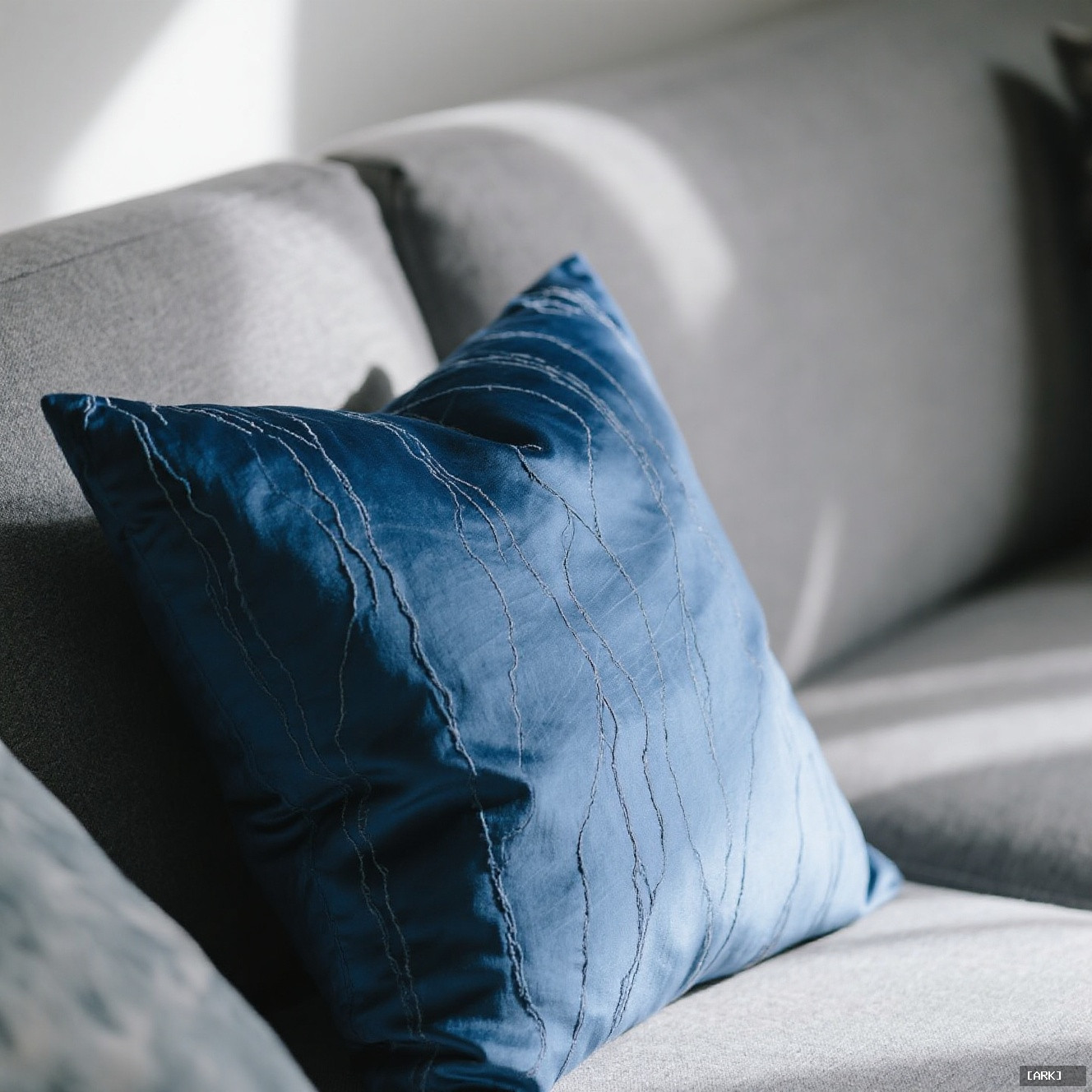 close-up detail of a navy blue dupioni silk cushion with visible slubs…, featuring Decorative silk cushions