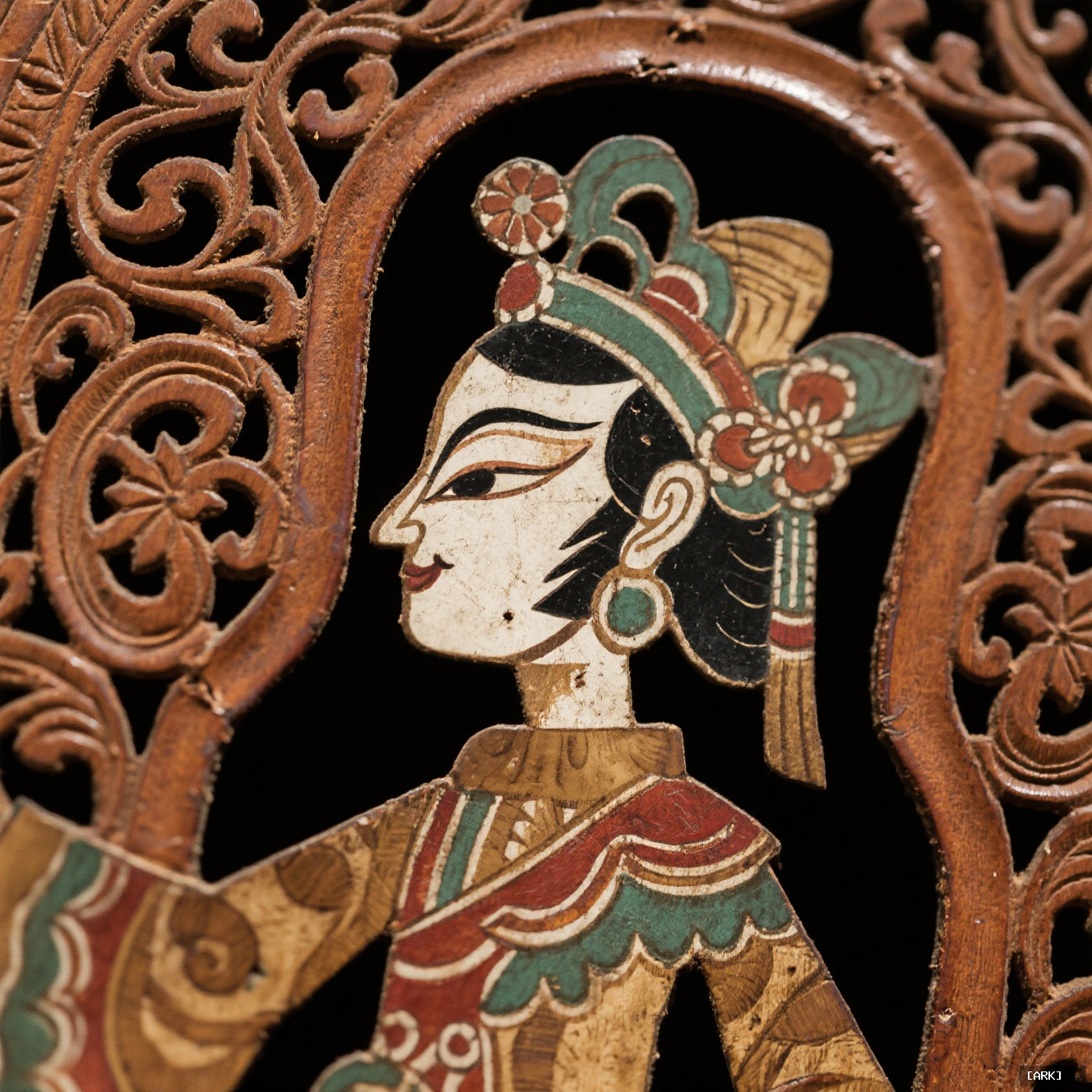 Close-up detail of an antique Chinese shadow puppet showing intricate hand-carved leather…, featuring Chinese shado…