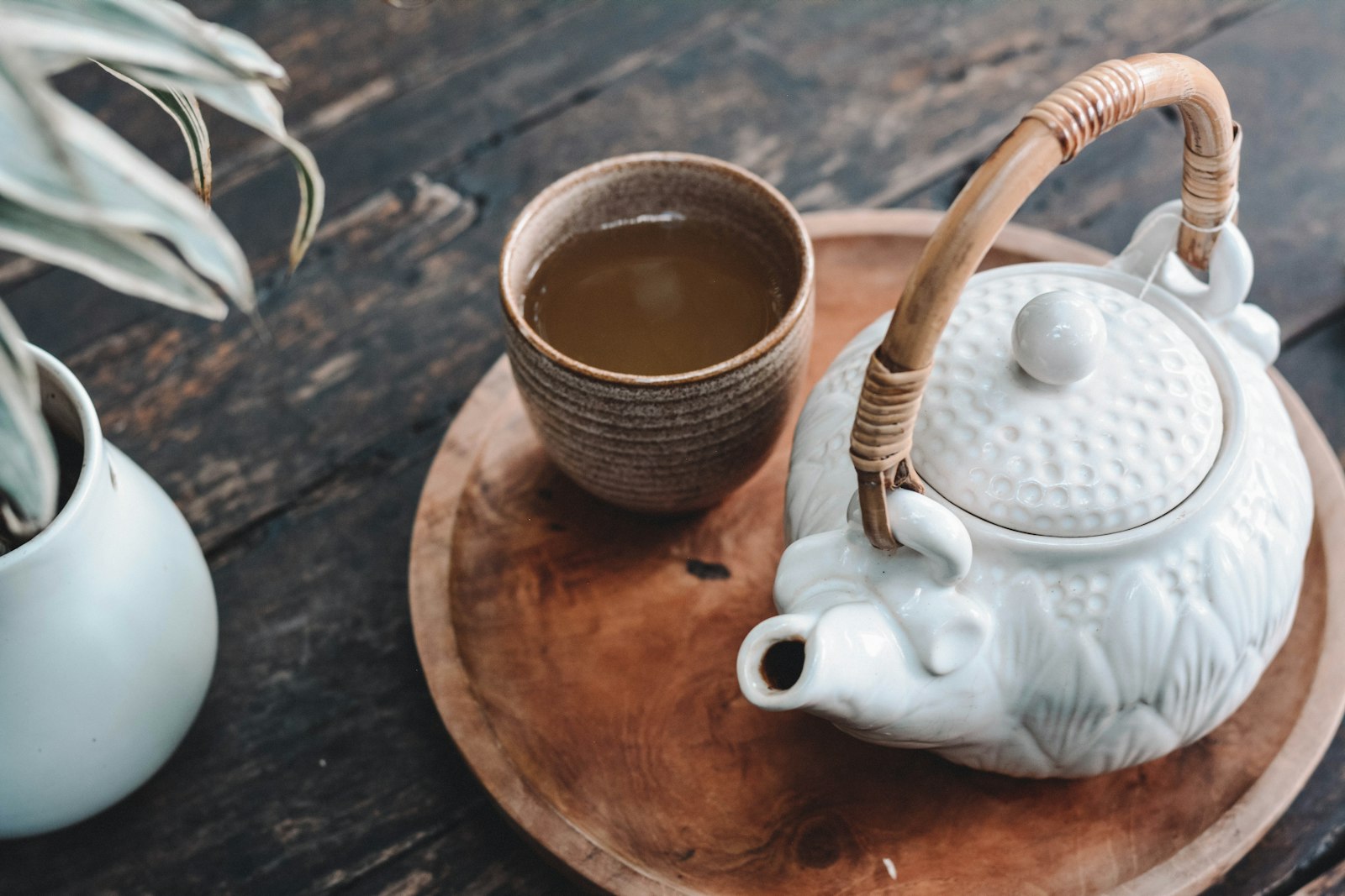 Yixing clay teapot being rinsed with hot water in a traditional workshop